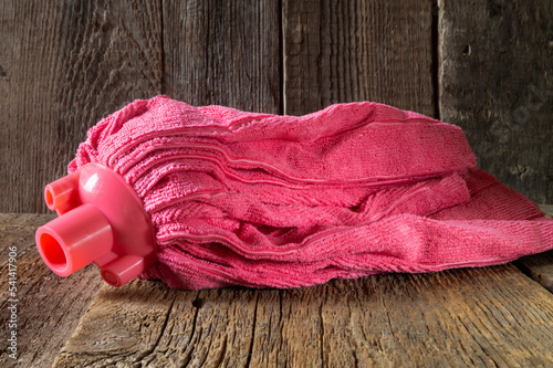 Pink microfiber mop head on the floor