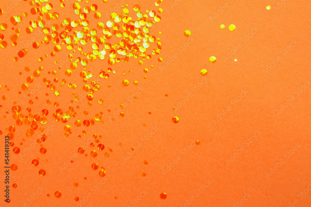 Shiny bright glitter on coral background, flat lay. Space for text Shiny bright glitter on coral background, flat lay. Space for text