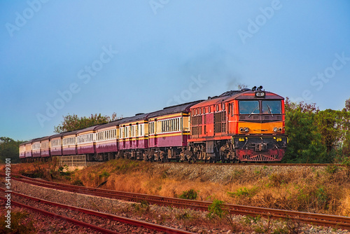 Passenger train by diesel locomotive on the railway.