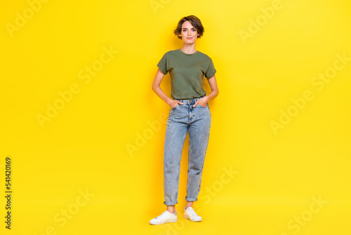 Full length photo of cute nice girlfriend hand pocket dressed fashionable street outfit empty space isolated on yellow color background