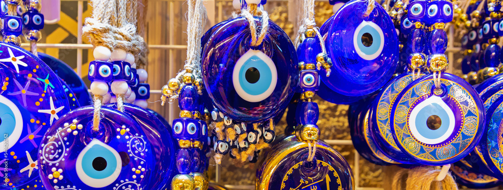Traditional Turkish amulet Evil Eye or blue eye (Nazar boncugu). Souvenir of Turkey and traditional turkish amulet. Banner. Travel souvenir or gift concept - obrazy, fototapety, plakaty 