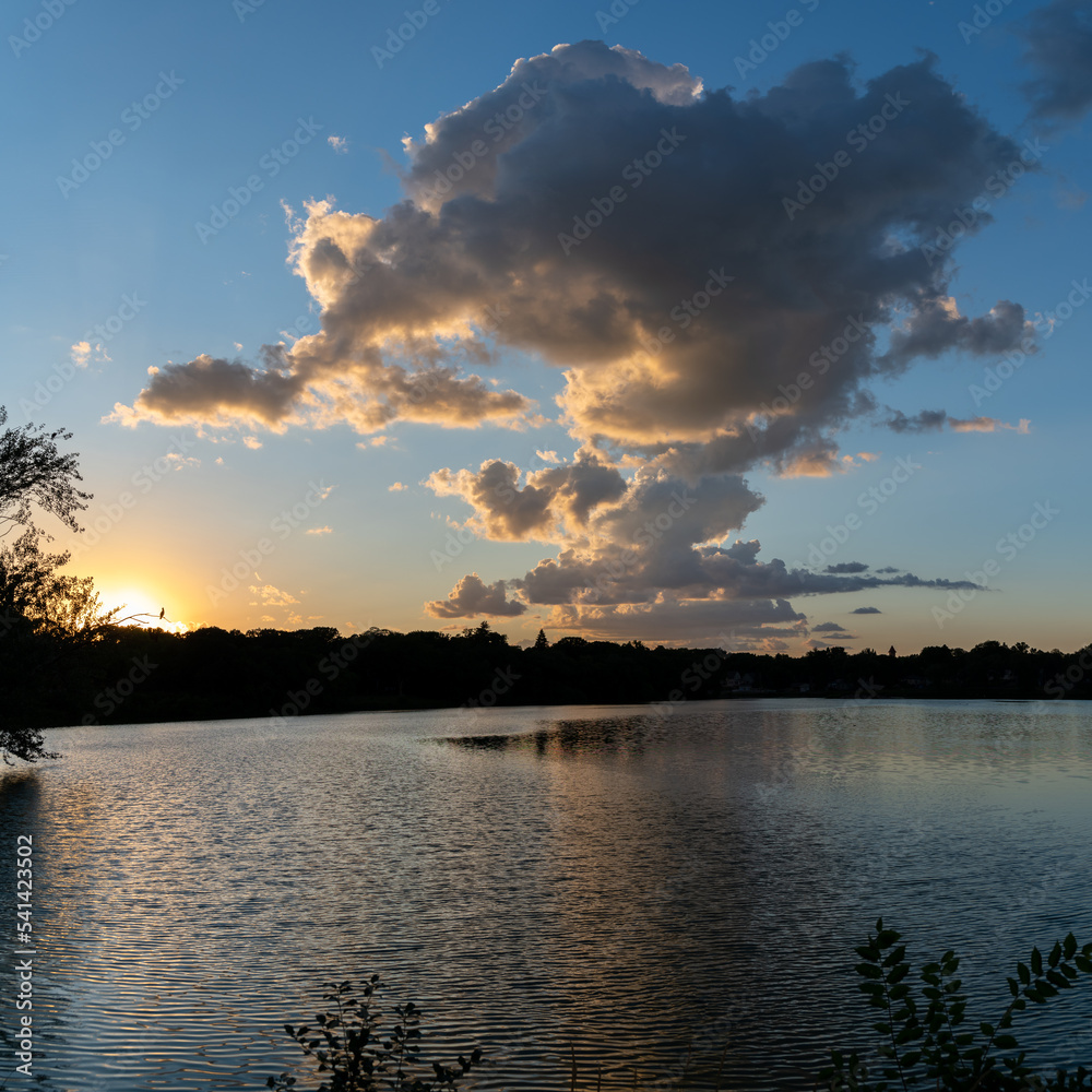 Clouds reflections and beautiful colors of a tranquil sunset at Lake Alice in Fergus Falls, Minnesota USA
Clouds reflections and beautiful colors of a tranquil sunset at Lake Alice in Fergus Falls, Minnesota USA