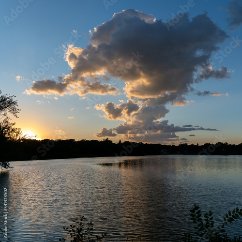 Clouds reflections and beautiful colors of a tranquil sunset at Lake Alice in Fergus Falls, Minnesota USA  © Barbara
