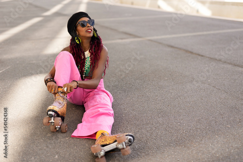 Urban woman enjoy outside. Modern woman posing with roller skates..