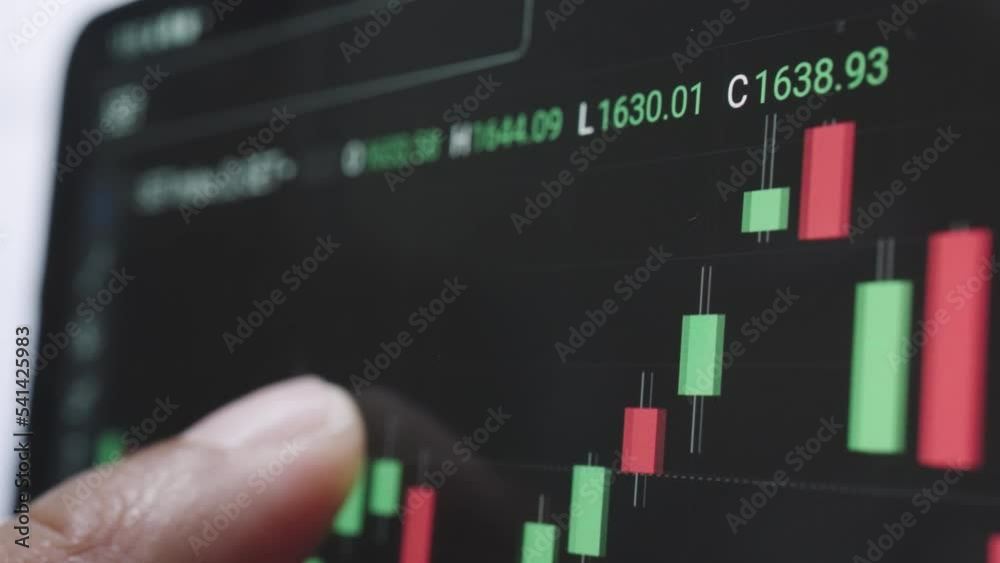 Close up of hands analyzing index graph on board in smartphone