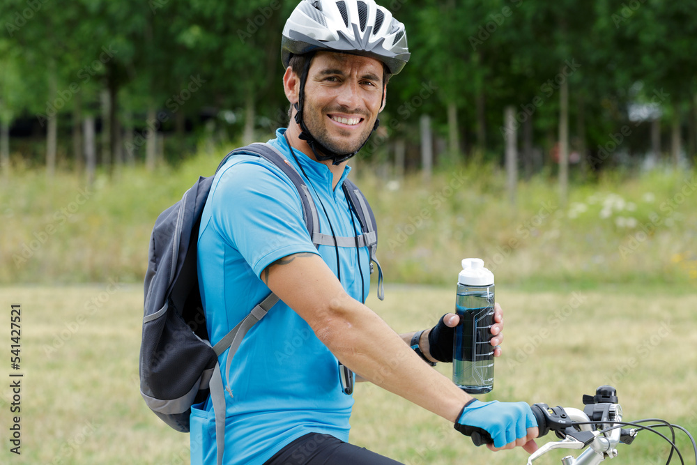 sport man on bike drinking water during rest sport man on bike drinking water during rest