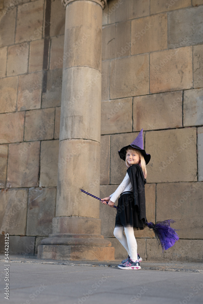 blonde girl in halloween costume violet wich hat and broom blonde girl in halloween costume violet wich hat and broom