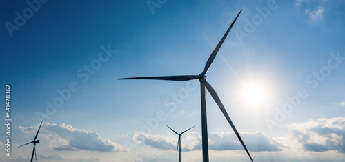 a modern wind turbine park panorama in front of a blue sky © Tobias Arhelger