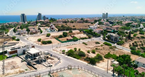 Aerial drone footage of the Russian orthodox church Saint Nicholas in Limassol, Cyprus. Fly over view of golden dome, bell tower, cross of religious russian architecture and city skyline from above.
