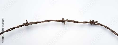 Rusty barbed wire on white isolate. White rectangular background with barbed wire.