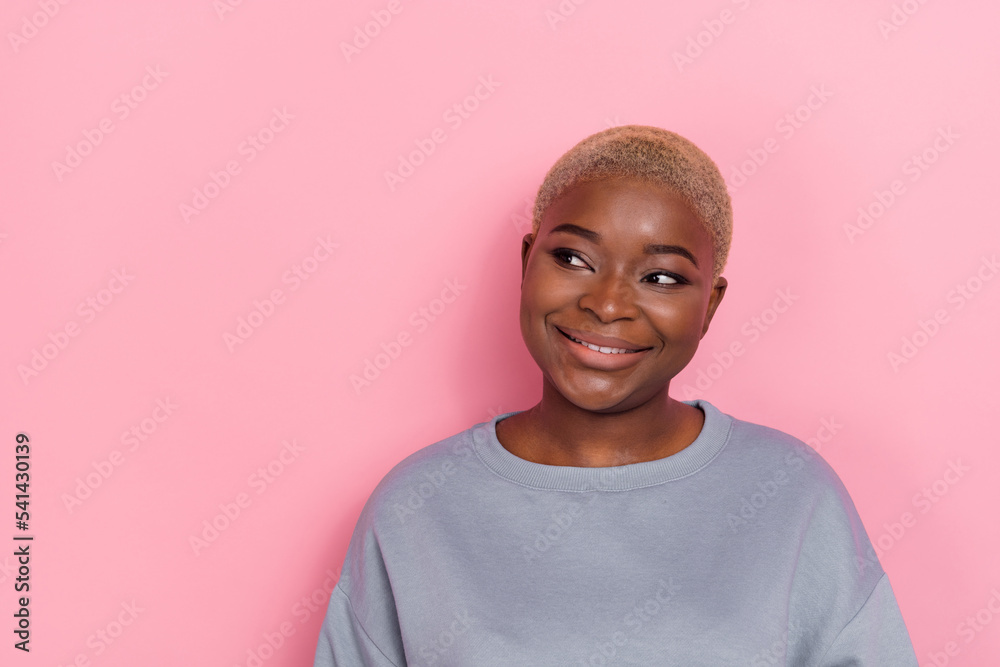 Photo of cheerful minded person look interested empty space toothy smile isolated on pink color background Photo of cheerful minded person look interested empty space toothy smile isolated on pink color background