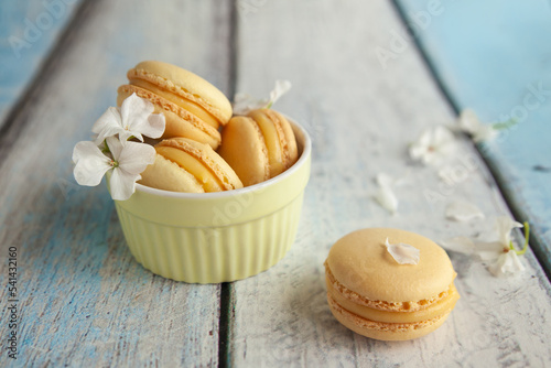 Traditional french yellow macaroons with white flowers