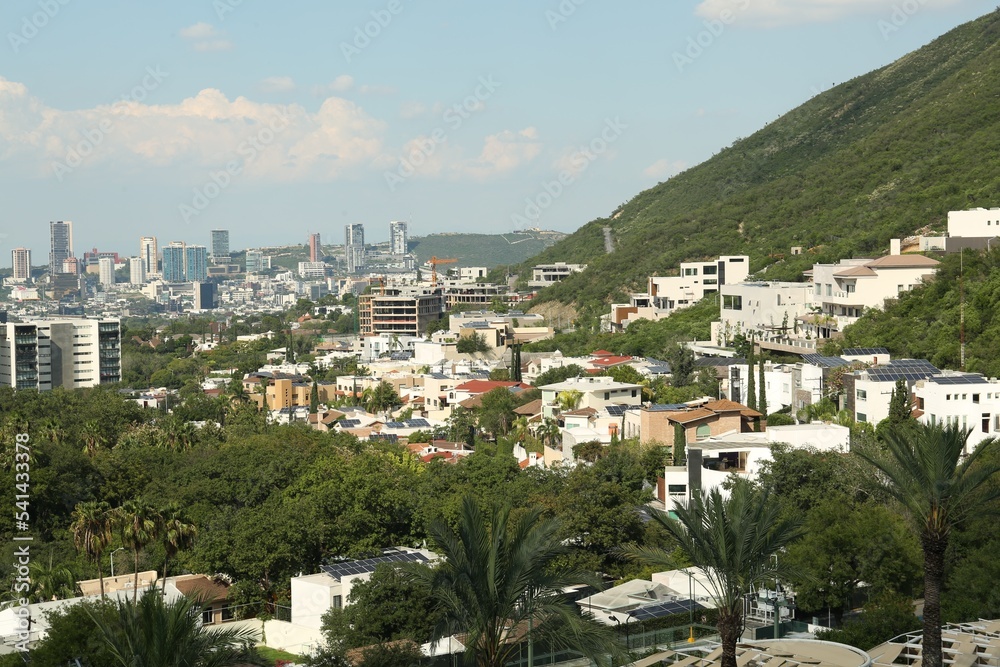 Picturesque view of city and green mountains