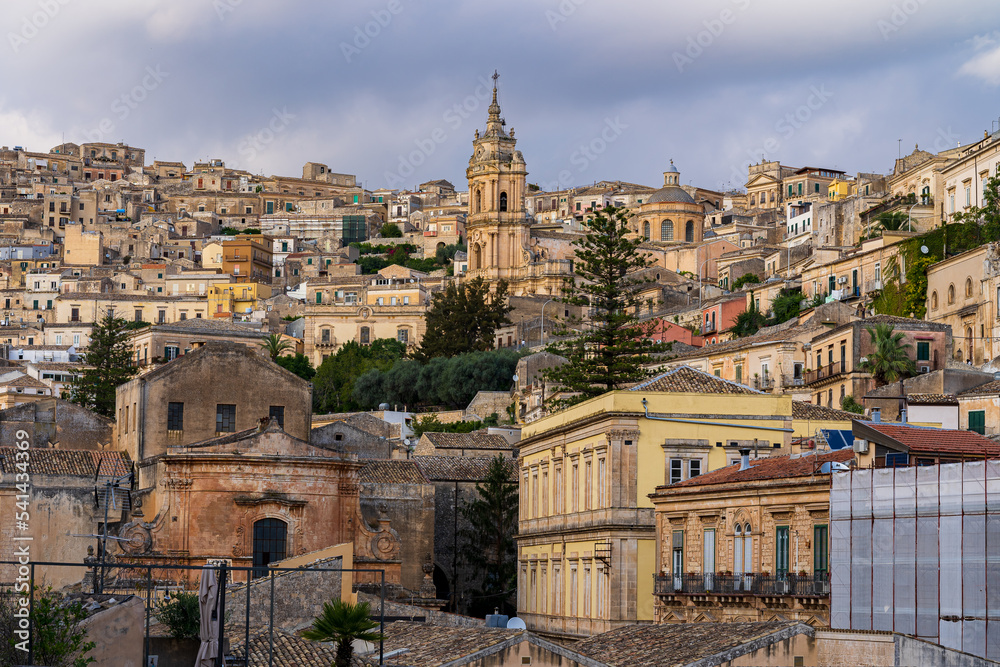 View of the old town of Modica in Sicily. Cathedral of Saint George tower in the center of the frame. Italy