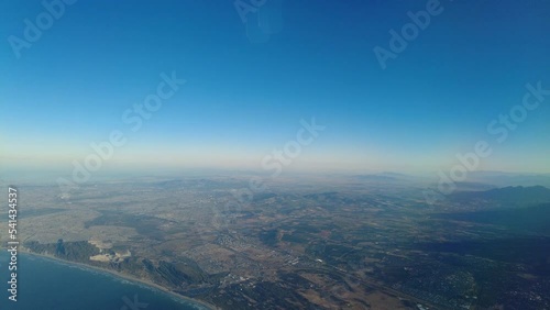 Flying over sea and mountains inside the plane aerial footage. photo