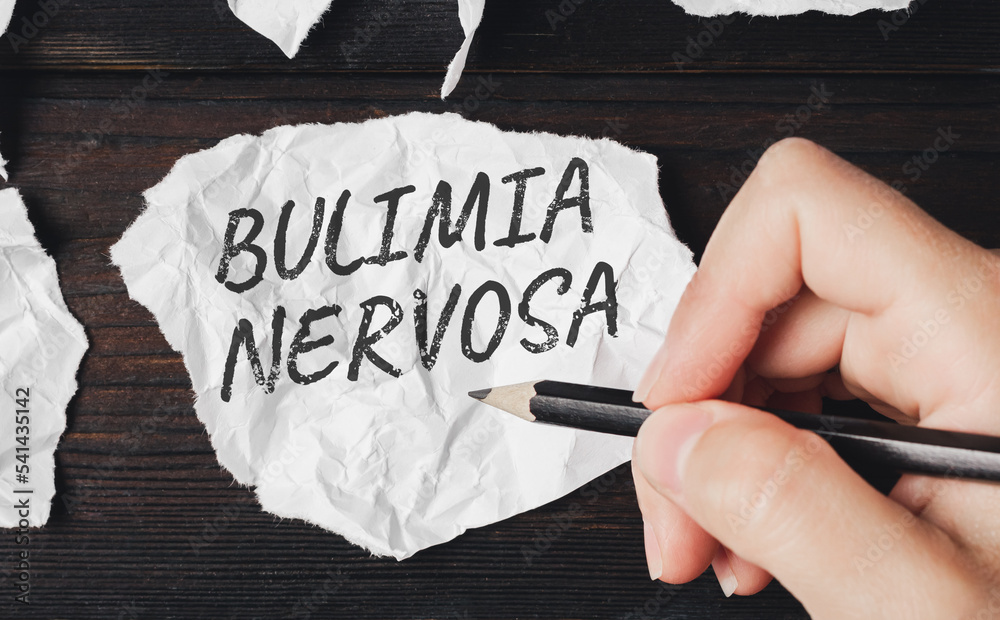 Bulimia nervosa is an eating disorder. Pencil writing on a piece of paper. - obrazy, fototapety, plakaty 