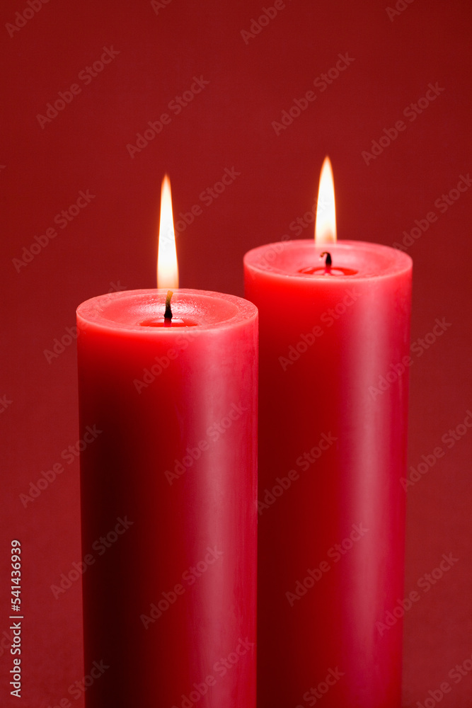red burning candles on red background
red burning candles on red background