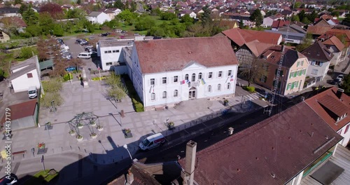 Drone aerial view of a town hall in Alsace, with a gendarmerie antenna in the foreground photo