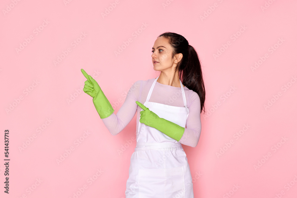 woman in rubber gloves pointing fingers aside at copyspace woman in rubber gloves pointing fingers aside at copyspace