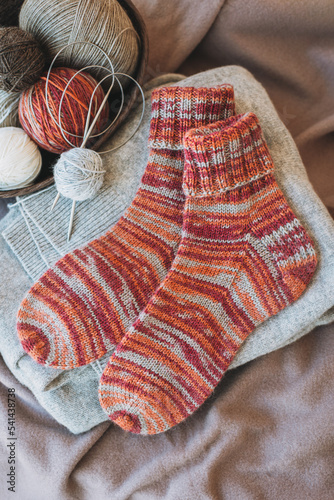 Hand knitted socks with needles and yarn ball. Concept for handmade and hygge slow life.