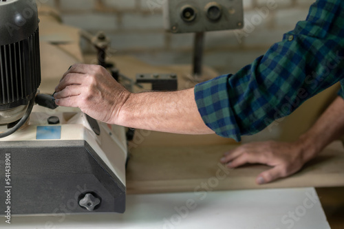 Carpenter working with wood in a workshop