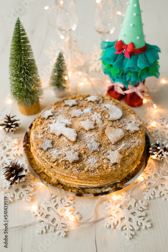 Christmas cake. A cake for Christmas. Christmas cake with lights. Christmas cookies on a wooden background.