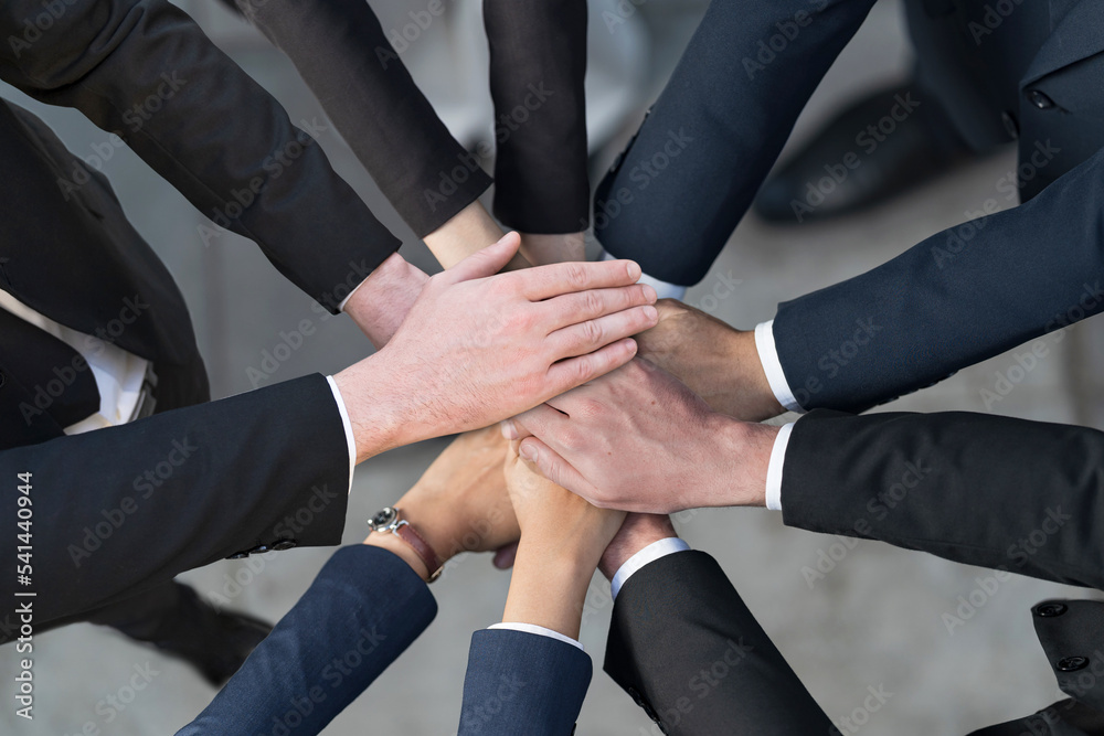 Cropped view of Group of Business people putting their hands together, Friends with stack of hands showing unity, Teamwork, Success and Unity concept Cropped view of Group of Business people putting their hands together, Friends with stack of hands showing unity, Teamwork, Success and Unity concept