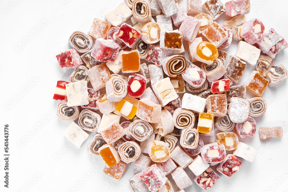 top view of a scattering of a mix of different jelly sweets such as lokum. background of sweets.