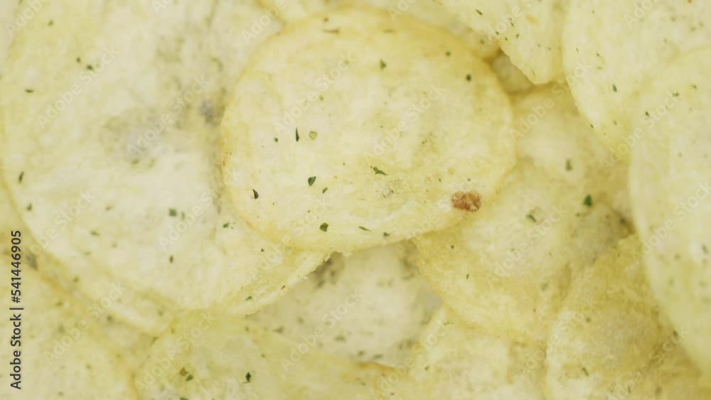 Potato chips on a rotating surface. Close-up. Food. Potato chips on a rotating surface. Close-up. Food.