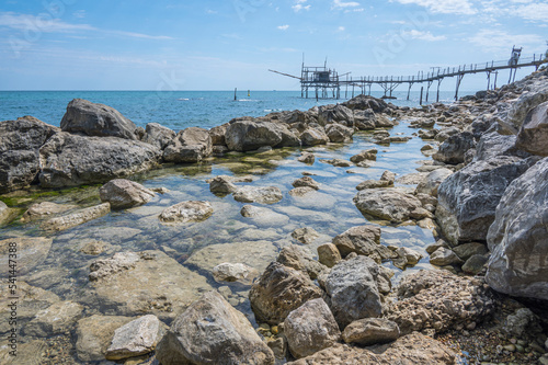 The beautiful beach of Calata Turchina with crystal clear and blue sea and the Trabocco in background photo