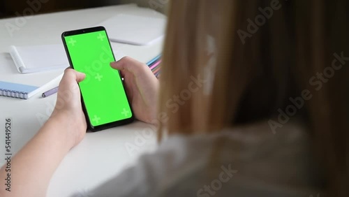 Teen girl playing games in smartphone