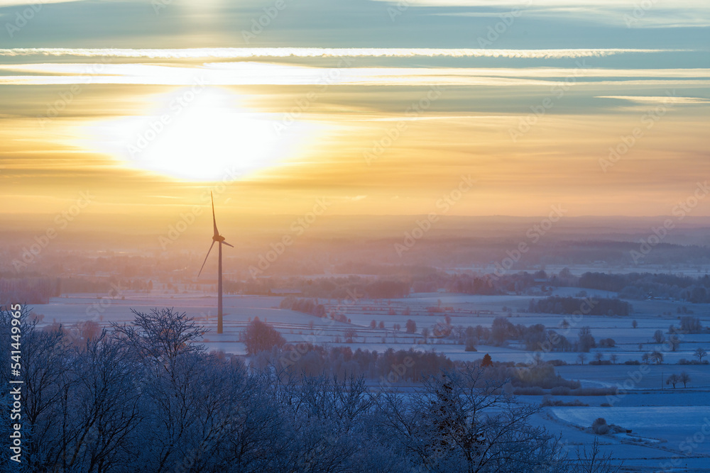 Wind turbines in a cold winter landscape at dusk Wind turbines in a cold winter landscape at dusk