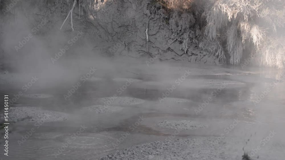 Static close-up shot of mud boiling and splashing with steam rising