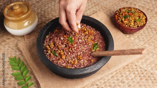 Ayurvedic porridge, Karkidaka Kanji herbal gruel in clay pot black background Kerala South India. Ayurveda diet health drink for immunity, cleanse the body. Top view medicinal porridge Indian veg food photo