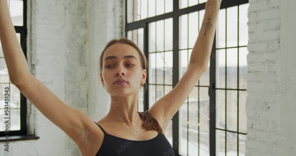 Modern female dancer in black outfit practices in a dance studio Modern female dancer in black outfit practices in a dance studio