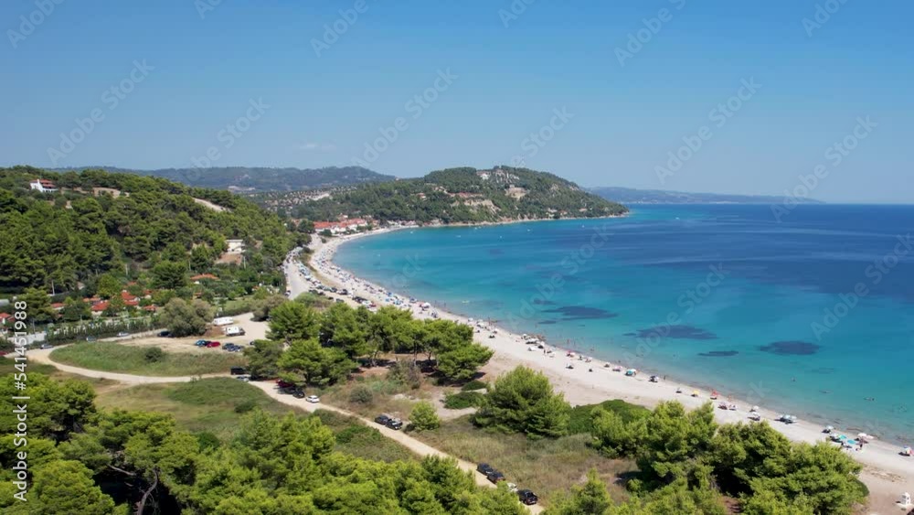 Aerial drone video of iconic turquoise and sapphire bay and beach of Possidi cape, Halkidiki, Greece. Beautiful view of a sandy beach with boats. Aerial drone video of iconic turquoise and sapphire bay and beach of Possidi cape, Halkidiki, Greece. Beautiful view of a sandy beach with boats.