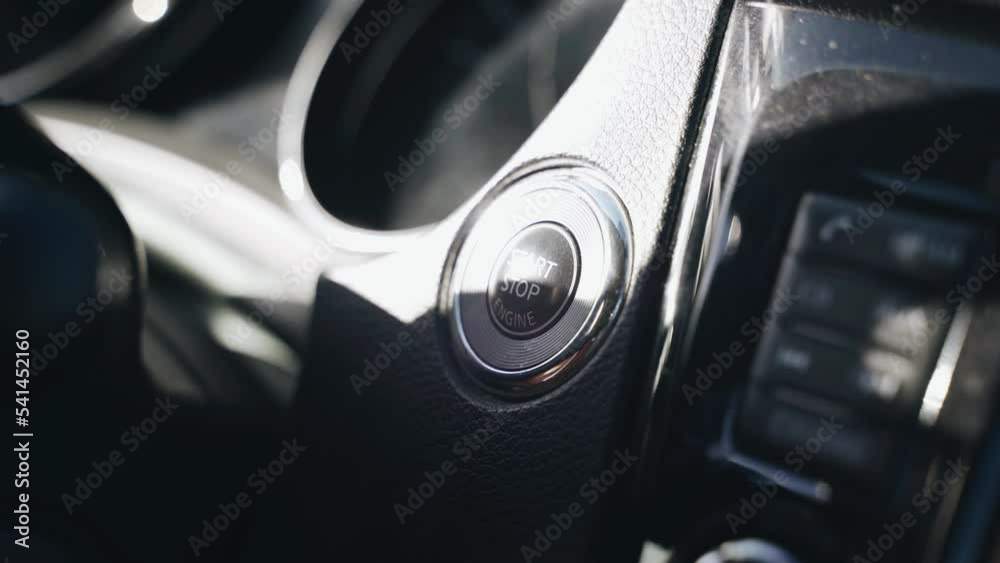 The driver presses the start button to start the car engine. Close-up of hands. Transport concept The driver presses the start button to start the car engine. Close-up of hands. Transport concept