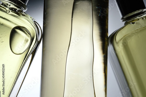 transparent jars with perfume lie on a light background. Close-up