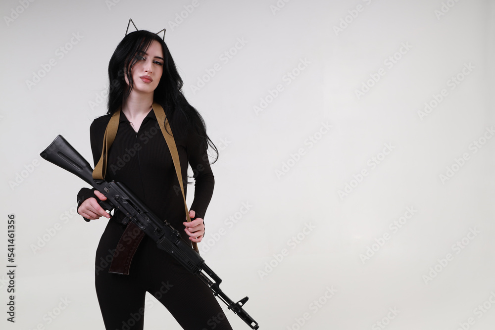 Slender glamour young woman with assault rifle Slender glamour young woman with assault rifle