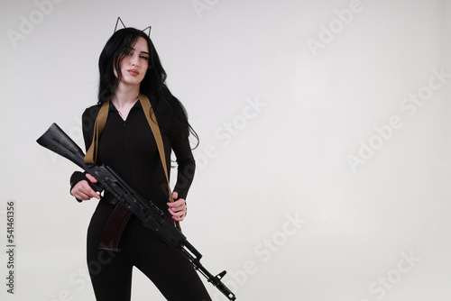 Slender glamour young woman with assault rifle