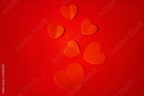 Red hearts on a red background