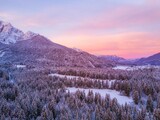 Aerial view of a sunset sky over the snowy Reservat Zelenci in Triglav national park, Slovenia
