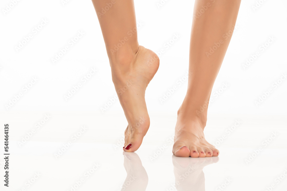 Front view of a beautifully cared female feet on a white background. Front view of a beautifully cared female feet on a white background.