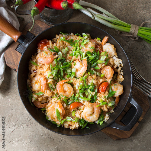 pan with fried rice with shrimps on the table