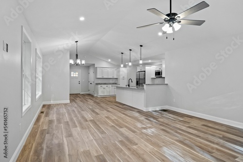 Beautiful newly renovated house corridor with hardwood floors and illuminated hanging lights