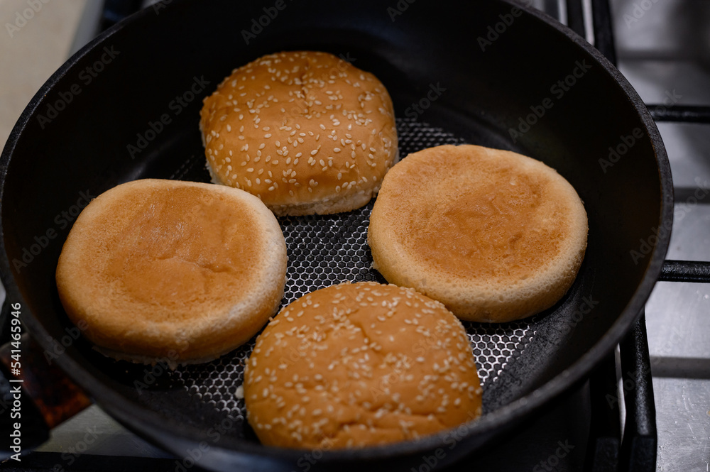 Freshly roasted Burger buns in close-up. Baking burger buns in a pan