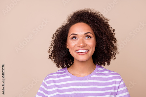 Closeup photo of young attractive adorable girl toothy smile look up new interesting information news isolated on beige color background © deagreez