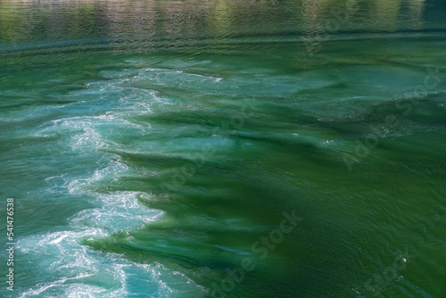 Water vortex of a ship's propeller in green water