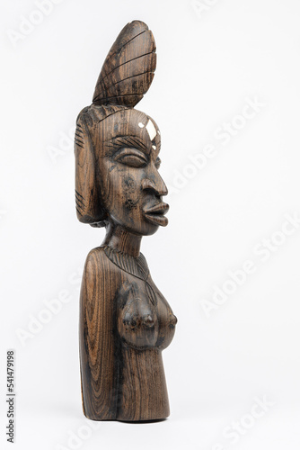 Wooden statue of an African woman isolated on white background, right view