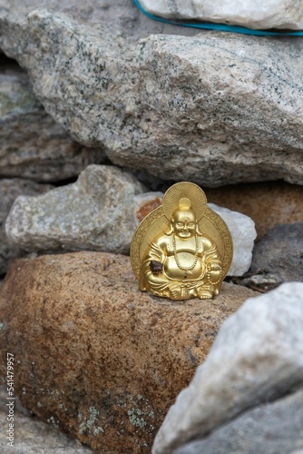 The golden figurine of God Hotei is a symbol of prosperity and well-being photo